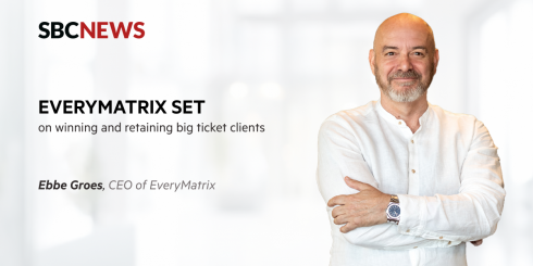 bbe Groes, CEO of EveryMatrix, smiling confidently in a white shirt, featured in an SBC News article discussing client growth and retention strategies.