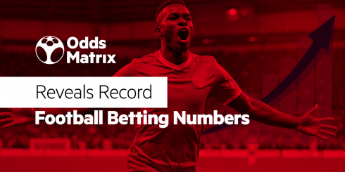 image in red background with a football player celebrating, OddsMatrix logo and text saying: Reveals Record Football Betting Numbers